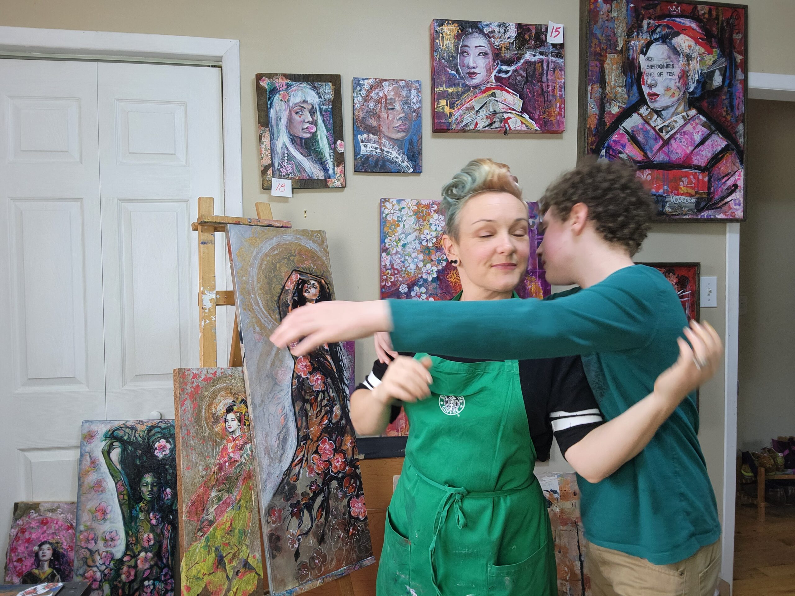 Hug.  I don't hug ut I do hug my kids a lot.  Sara Leger in her art studio getting a hug from her youngest son.