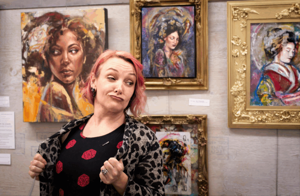 Contemporary artwork that connects emotionally – Sara Léger making a face standing in front of her paintings