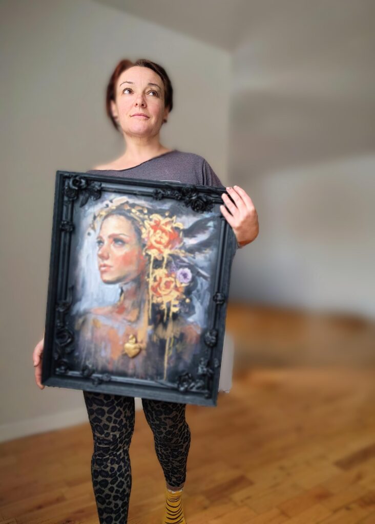 Image of “She Talks to Angels” being held by the artists Sara Leger