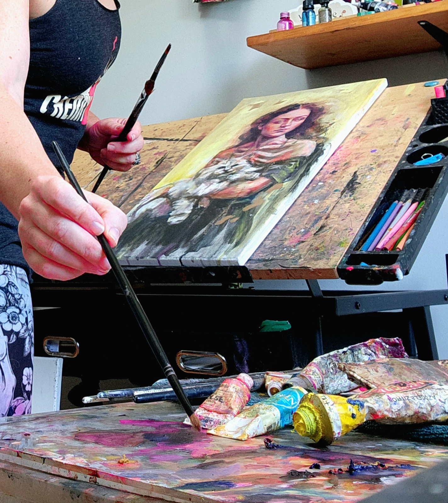 Canadian artist Sara Leger working on an original painting in her South Glengarry Ontario studio